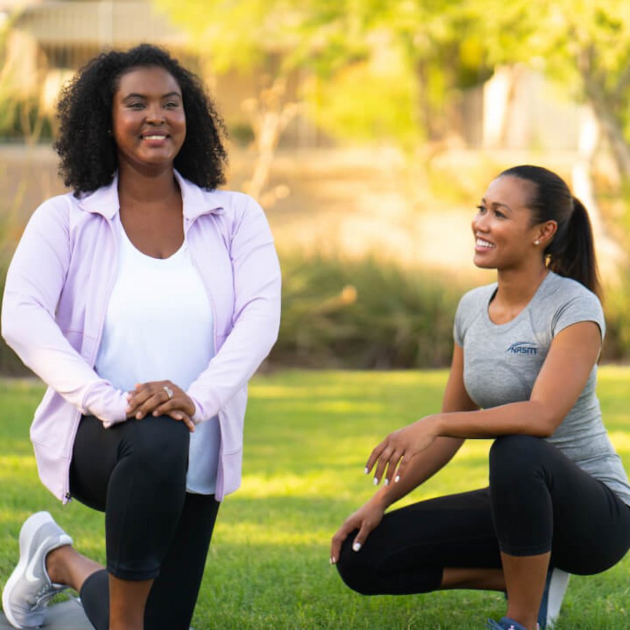 A female trainer helping a female client